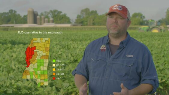 A farmer with an graphic showing K20 usage in the mid south.