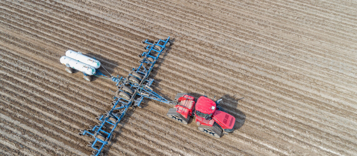 Aerial view of tractor applying Anhydrous Ammonia to corn field, Marion County, Illinois.