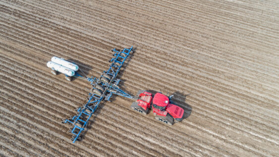 Aerial view of tractor applying Anhydrous Ammonia to corn field, Marion County, Illinois.