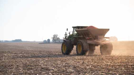 fertilizer spreader in harvested fall farm field
