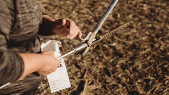 Farmer Opening Soil Sampling Probe with Soil Core