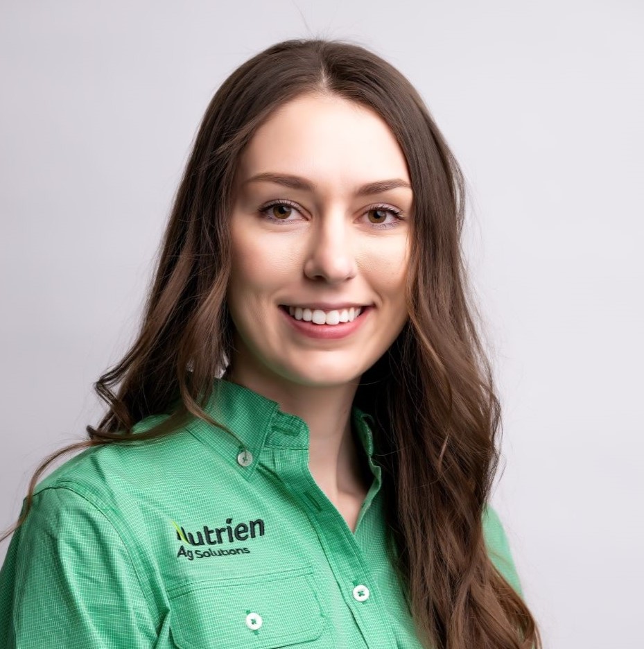 Photo of Stacie Yaremko in a green Nutrien Ag Solutions shirt in front of a grey backdrop.