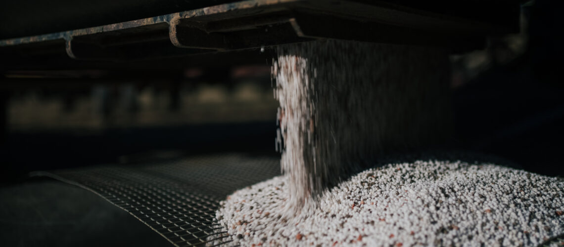 A blend of fertilizer prills preparing for application.